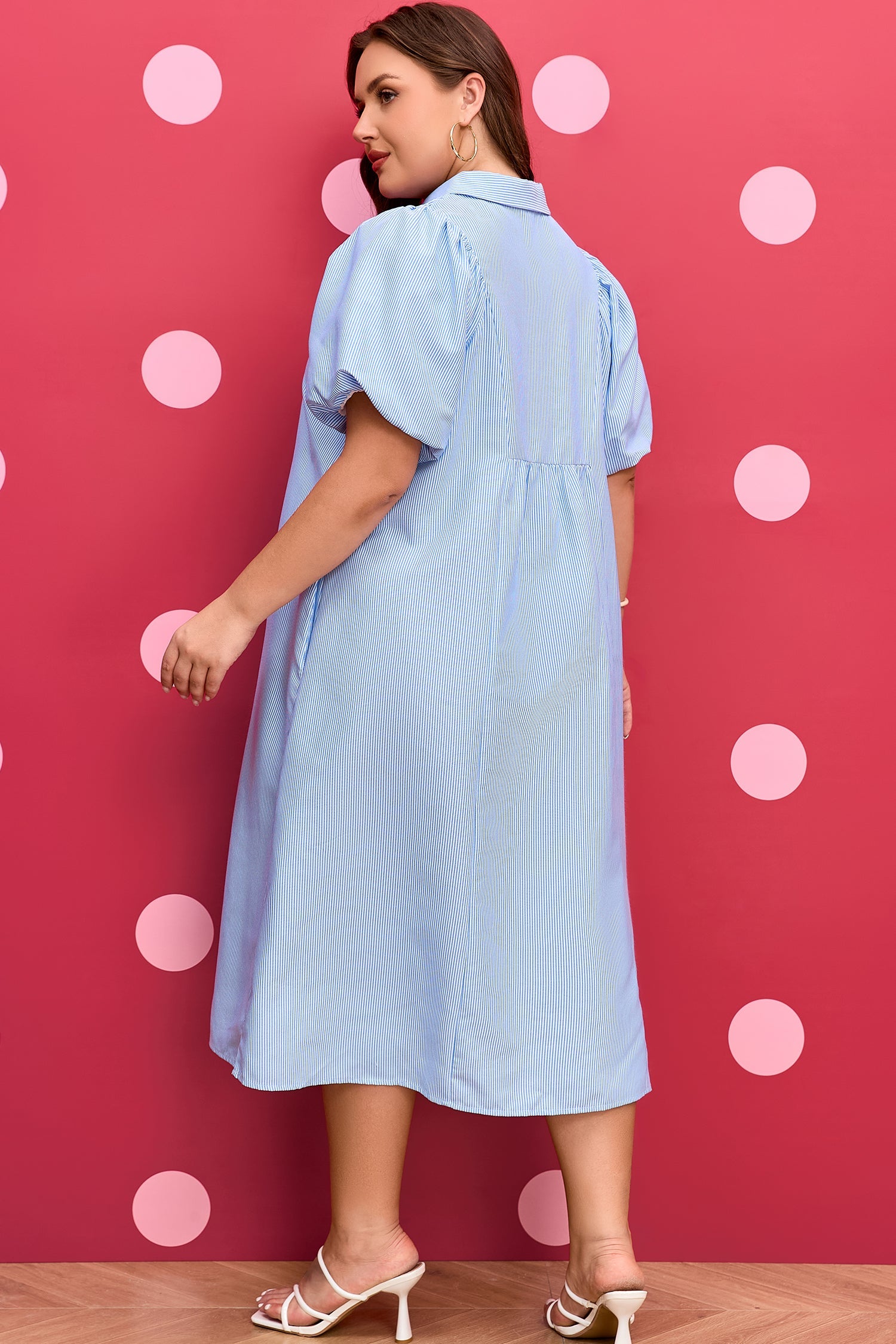 Plus-size light blue striped midi dress shown from the back with puff sleeves and yoke.