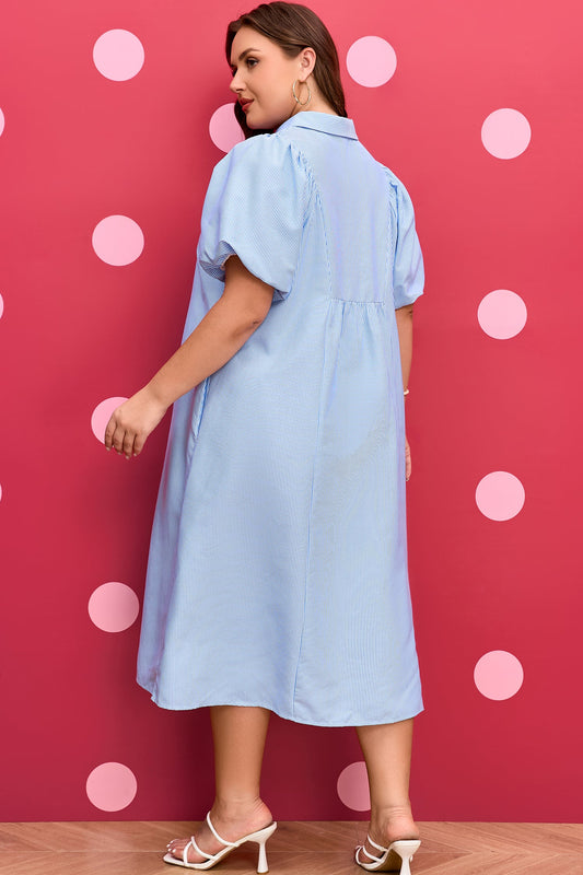 Plus-size light blue striped midi dress shown from the back with puff sleeves and yoke.