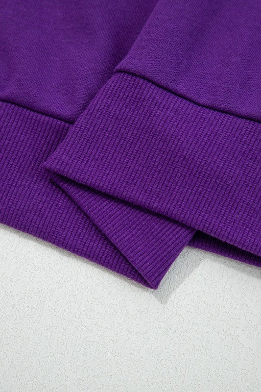 Ribbed knit cuffs on a purple pullover sleeve