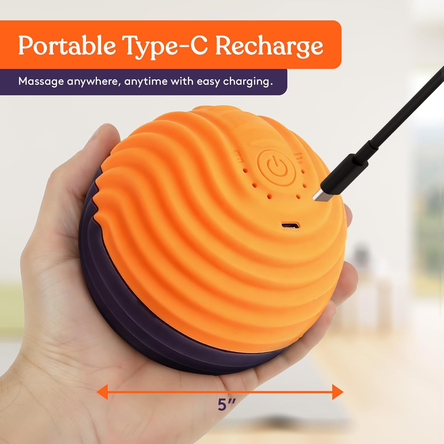 Orange vibration ball with ridged silicone surface and charging port