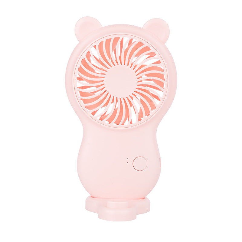 Pink handheld pocket mini fan with round grille, bear ears, and power control button