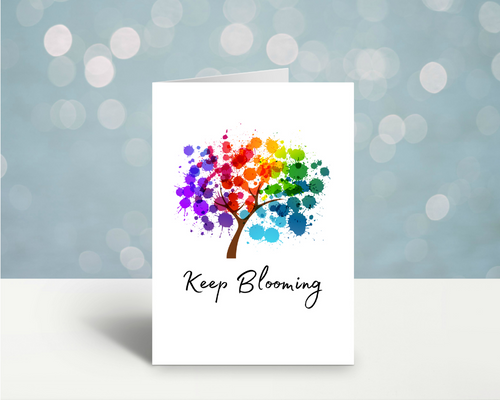 Greeting card with colorful blooming tree art and 'Keep Blooming' lettering
