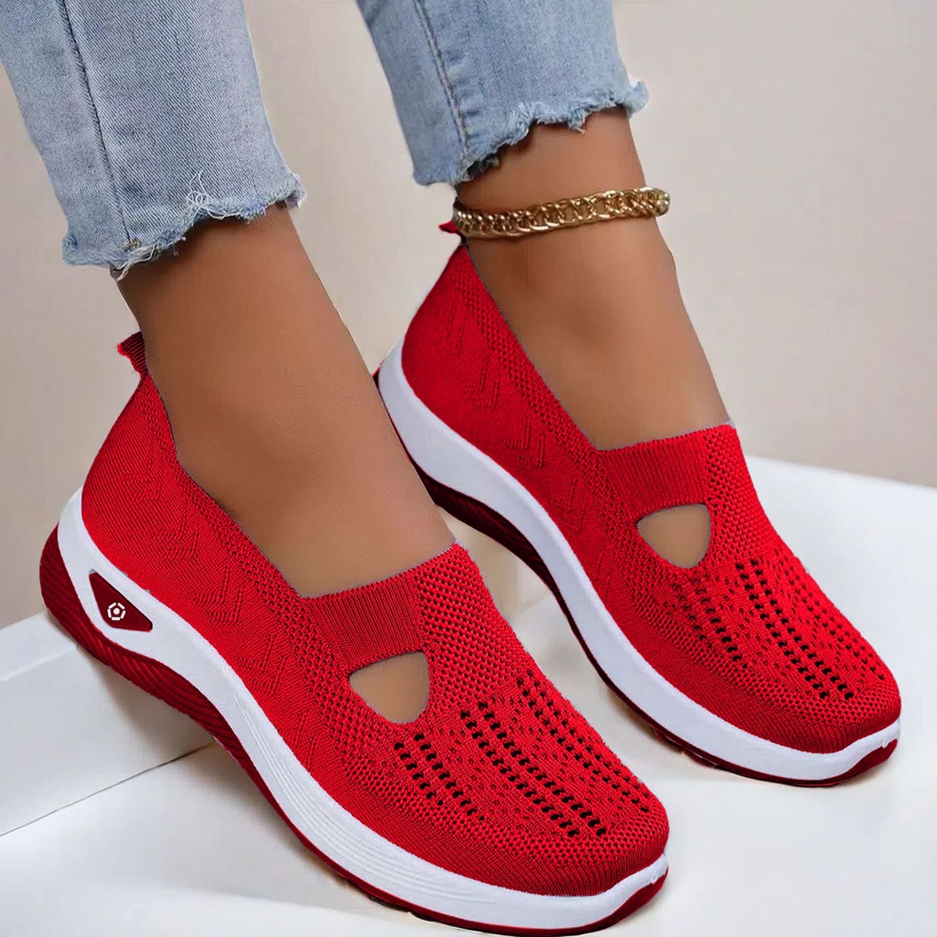 Red knit mesh slip-on flats with round cutout and white cushioned sole
