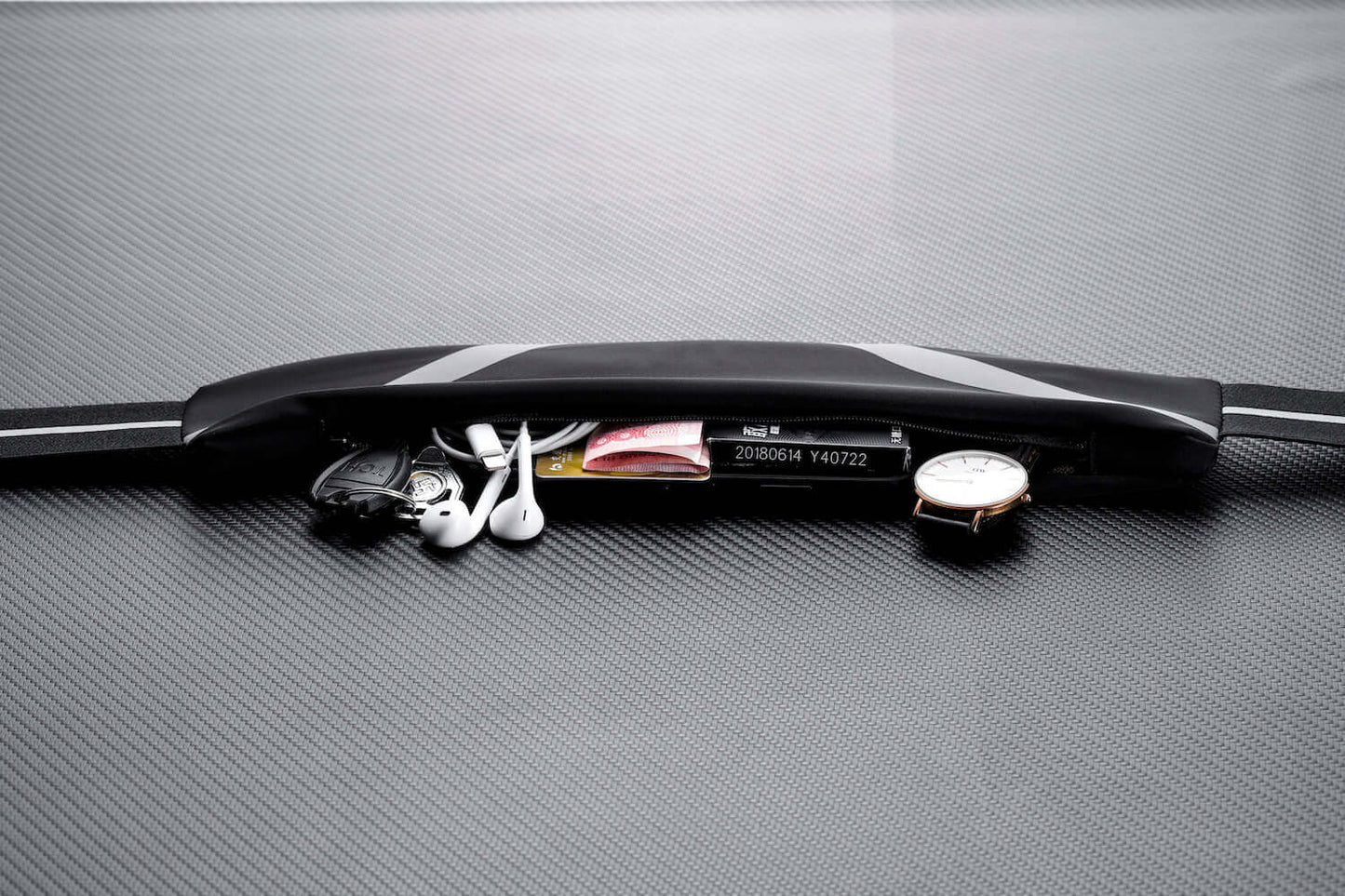 Water-resistant sport waist pack belt, black with reflective strip and zip compartment.