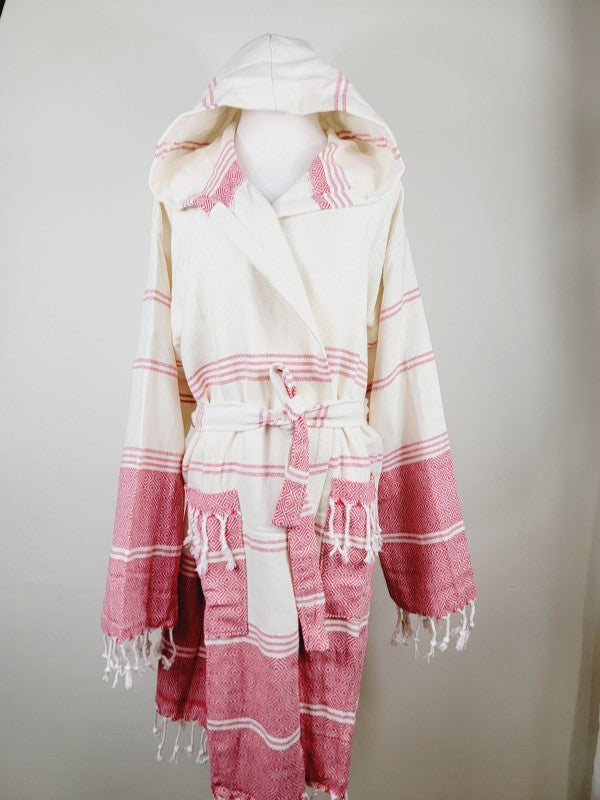 Unisex hooded bathrobe front view: cream and pink patterned fabric with tie belt and fringed hem.