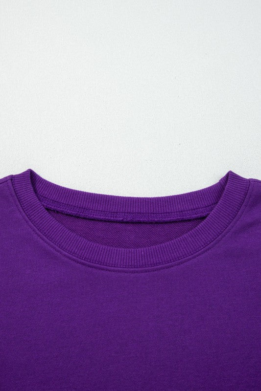 Purple crewneck pullover with ribbed collar and smooth knit fabric