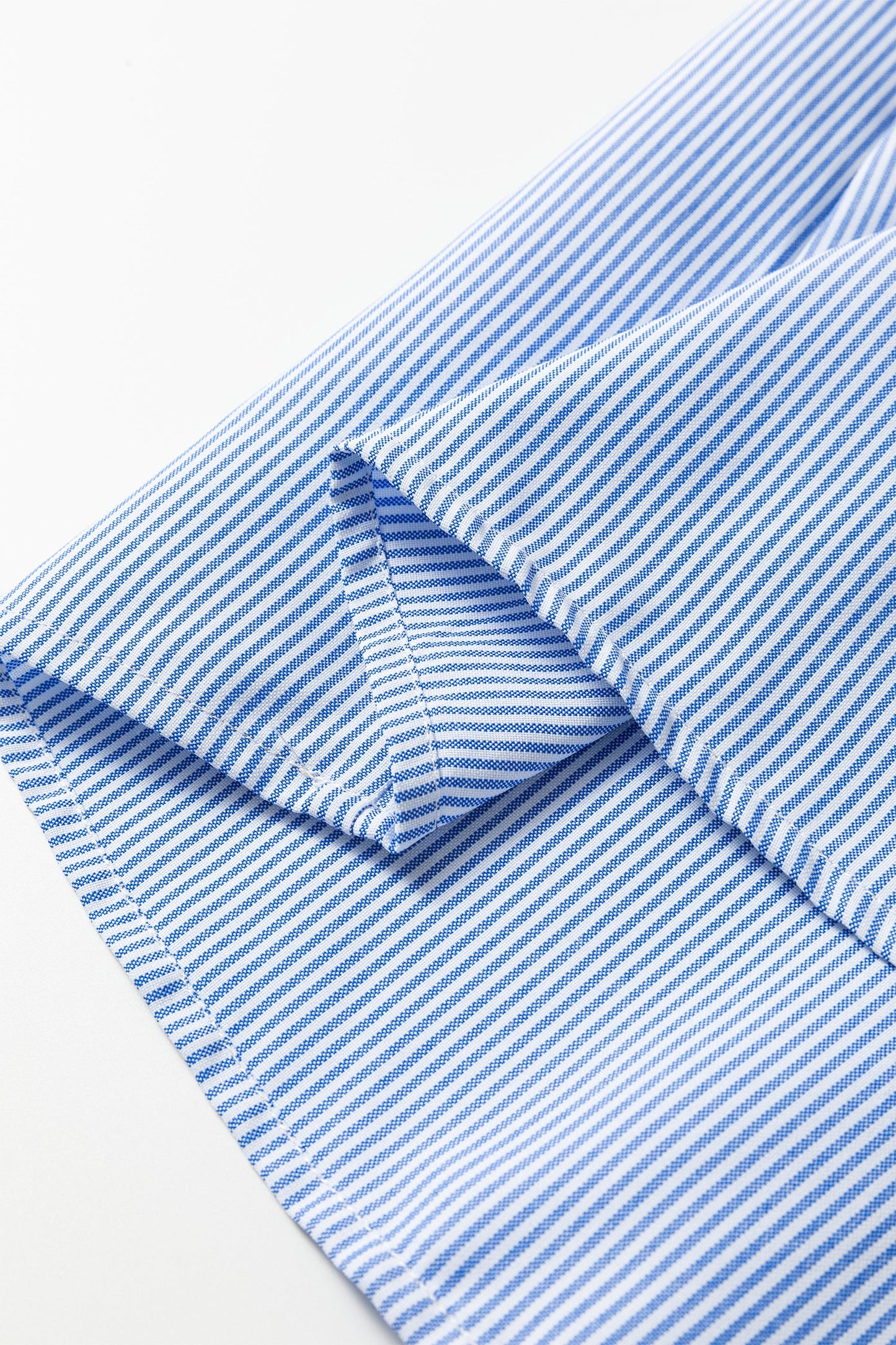 Sky blue striped sleeve cuff and seam close-up