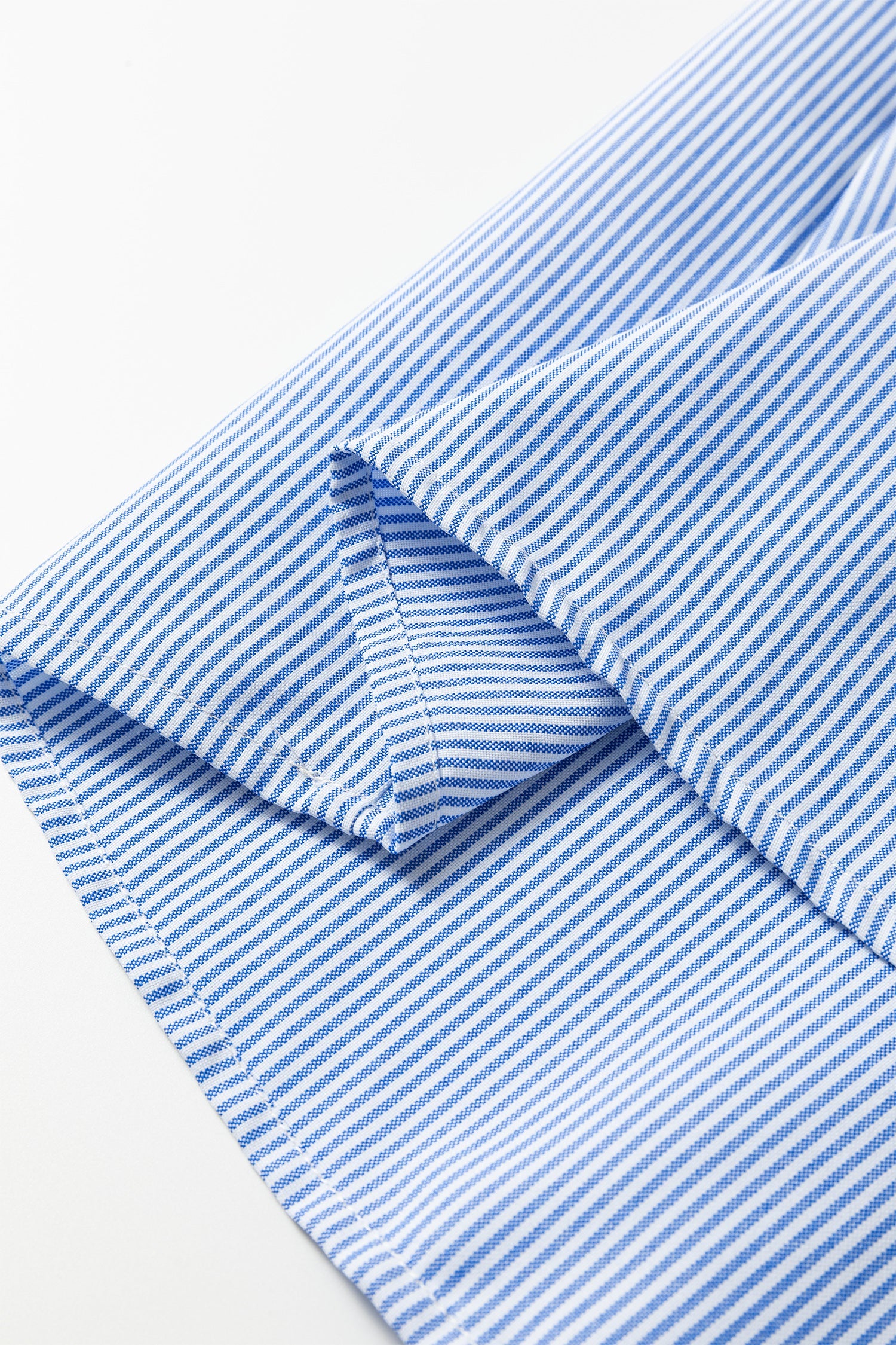 Sky blue striped sleeve cuff and seam close-up
