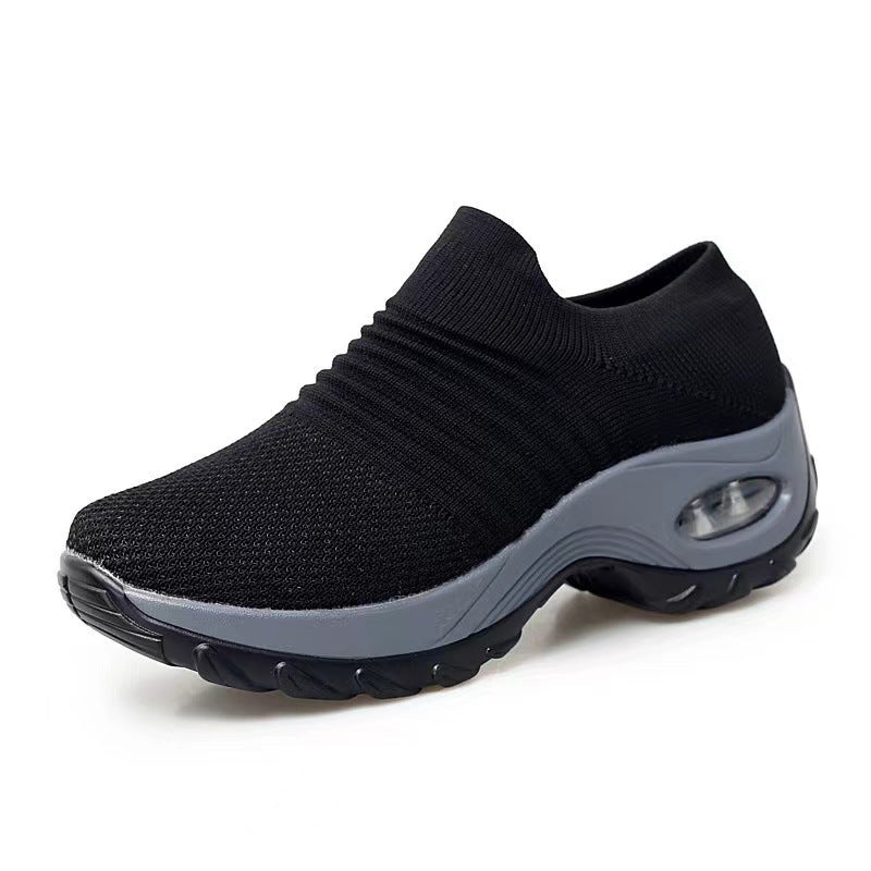 Black knit slip-on sneakers with gray sole and visible air-cushion window