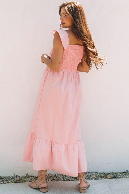 Apricot pink maxi dress side view with smocked bust and tiered ruffle hem