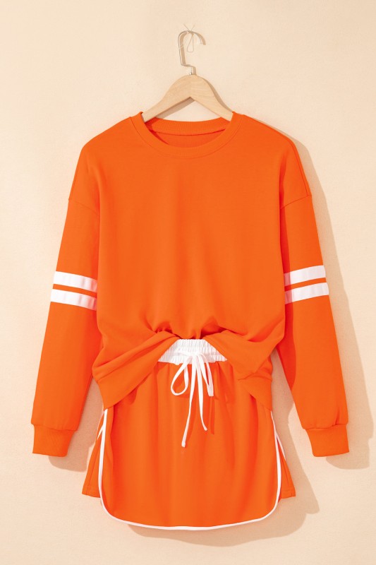 Orange varsity stripe pullover and mini skirt set with white sleeve stripes and waist ties
