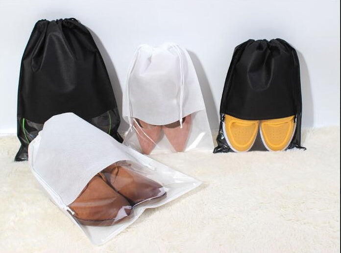 Black and white drawstring shoe storage bags with shoes inside, including yellow pairs.