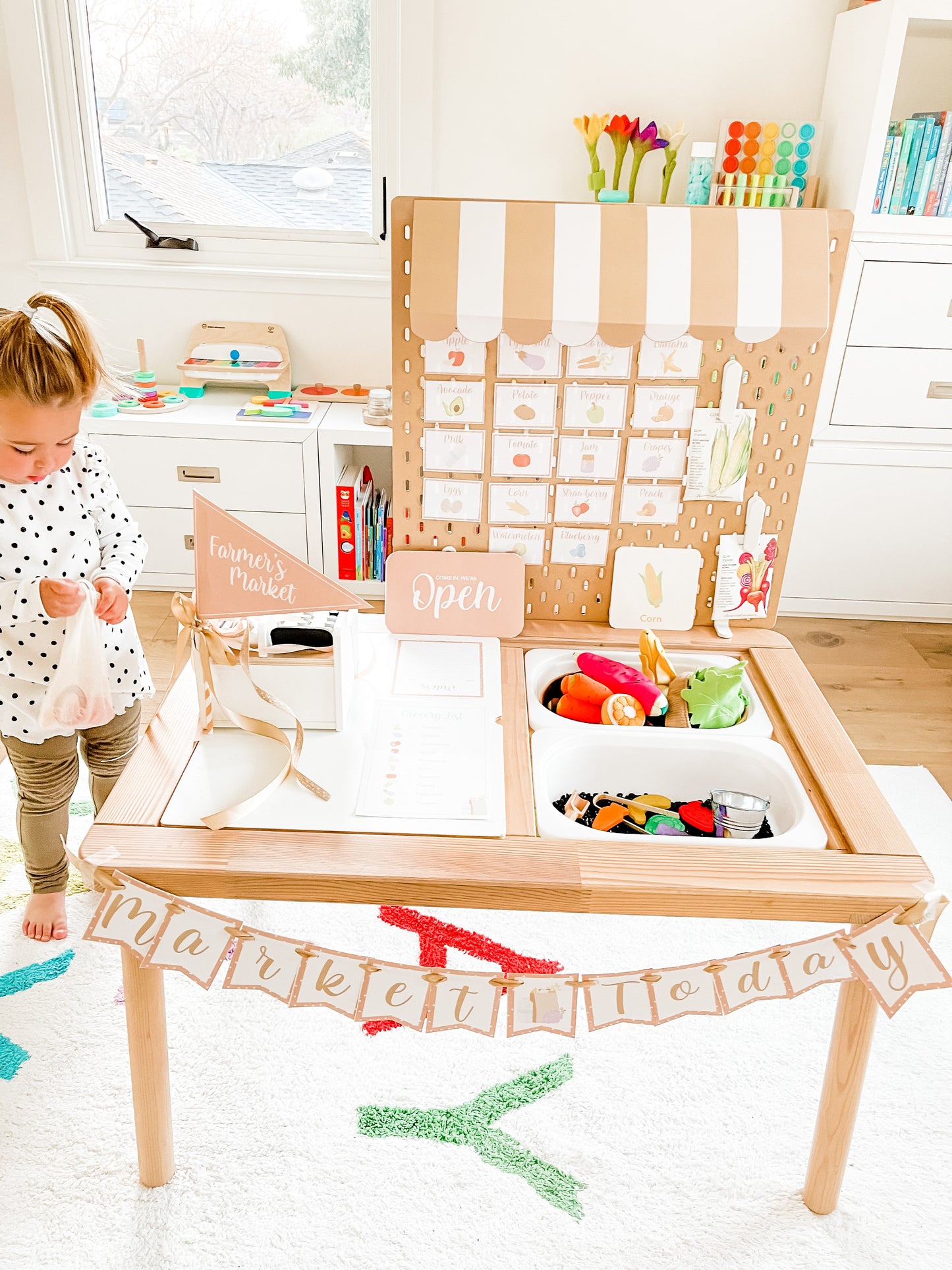 Dramatic play farmer's market stand with open sign, food cards, and wooden counter