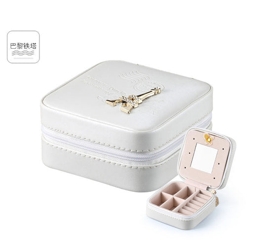 White jewelry organizer case with hinged mirror, zipper, and divided ring compartments