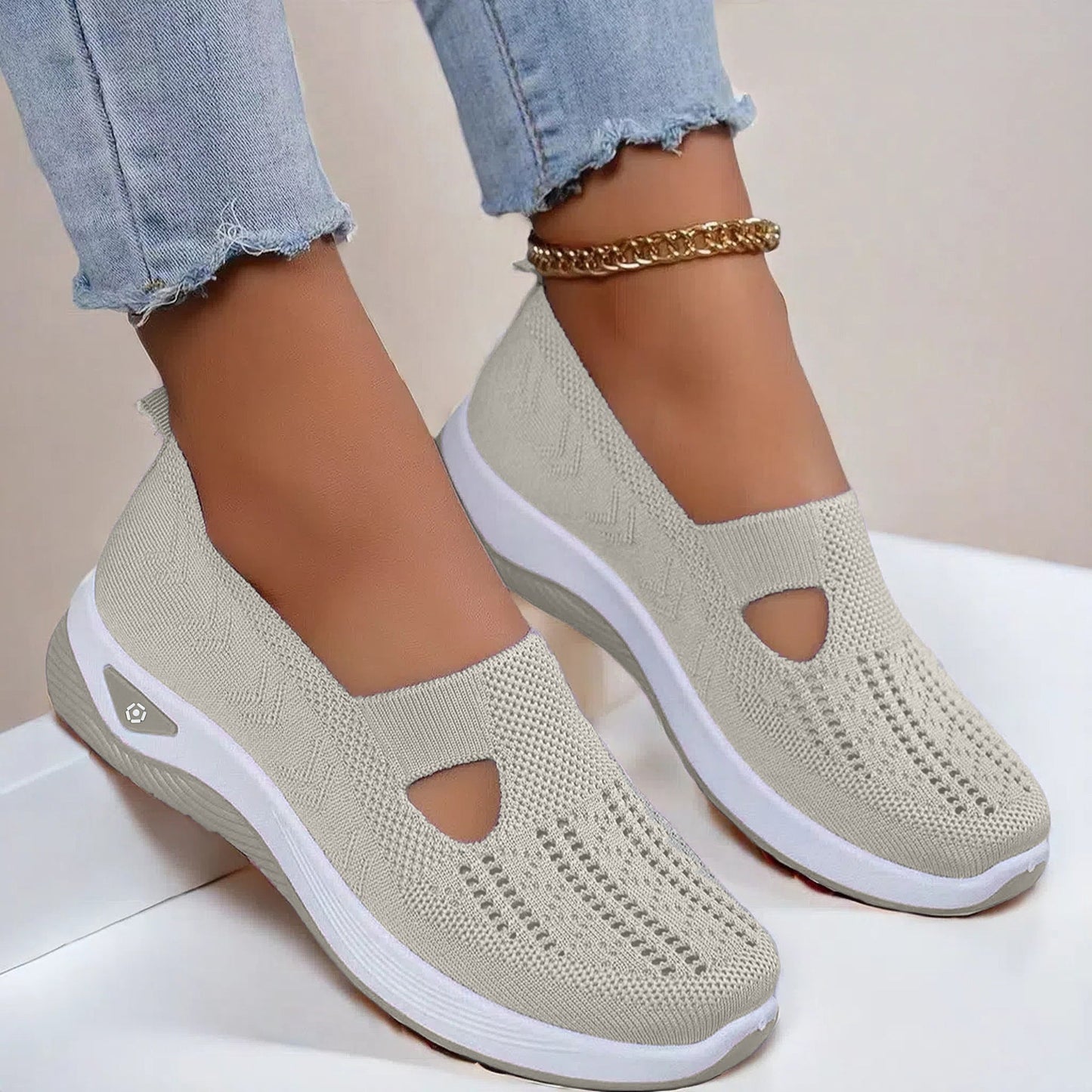 Cream knit mesh slip-on flats with round cutout and white cushioned sole