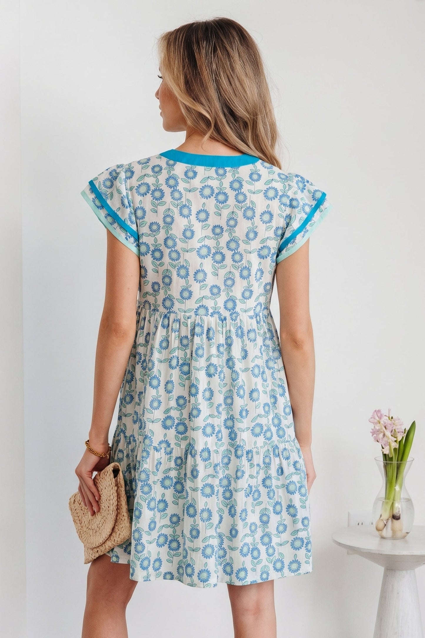Sky blue mini dress, back view with flutter sleeves and allover floral print