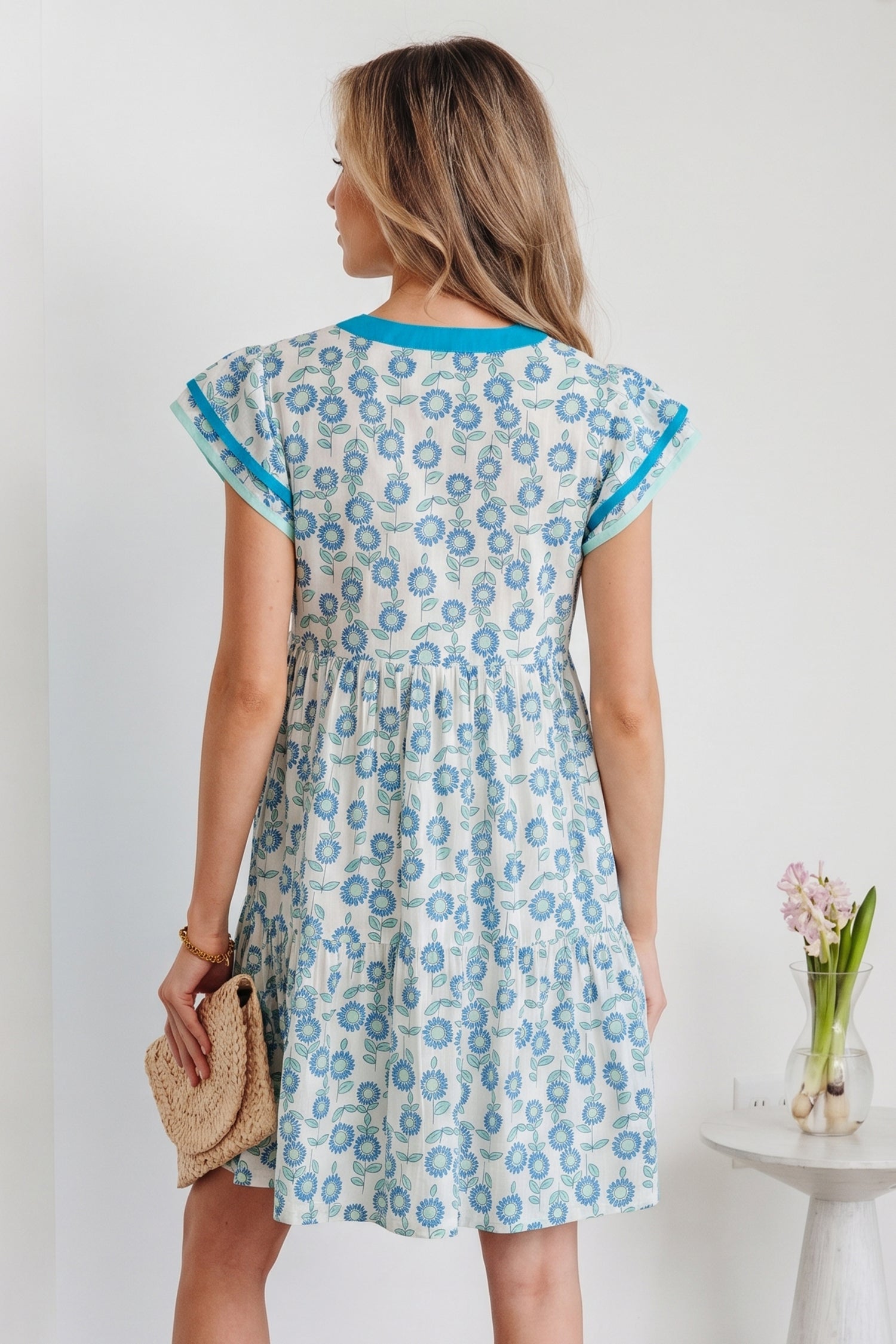 Sky blue mini dress, back view with flutter sleeves and allover floral print