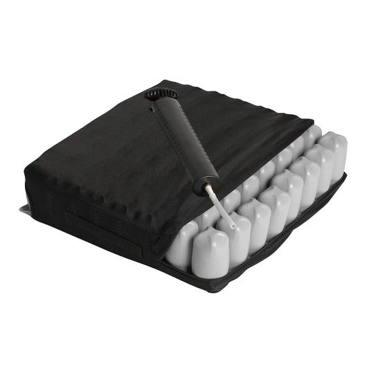 Black wheelchair cushion with contoured foam cells and valve, padded zippered cover