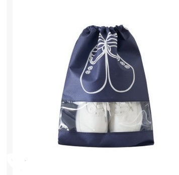 Navy blue drawstring shoe storage bag with white shoe icon, holding white shoes.