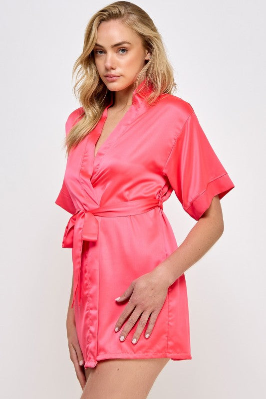 Hot pink satin V-neck robe with tied waist belt and short sleeves, side view