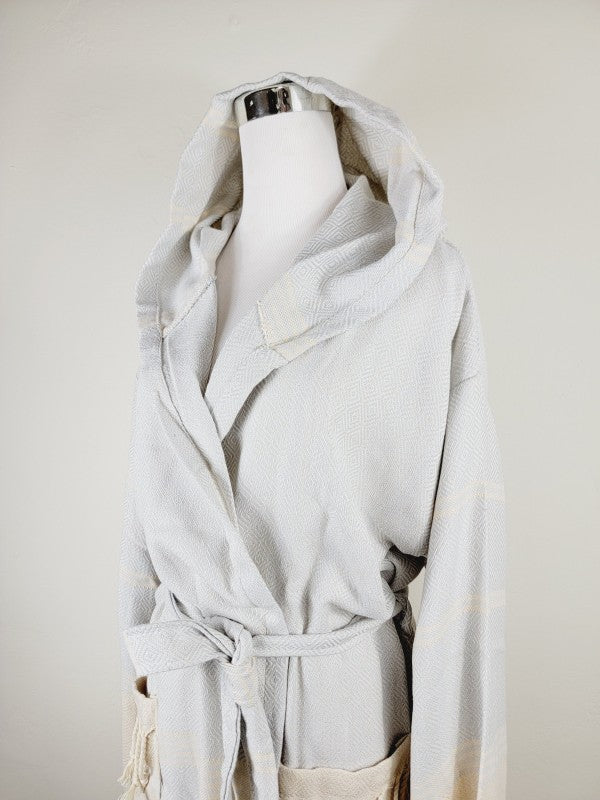 Light white hooded bathrobe with wrap front, belt tie, and front pocket openings