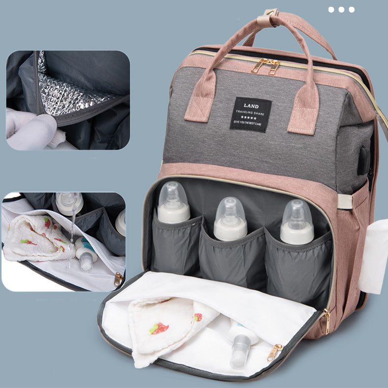 Baby crib backpack with front opening, gray and mauve organizer compartments for bottles
