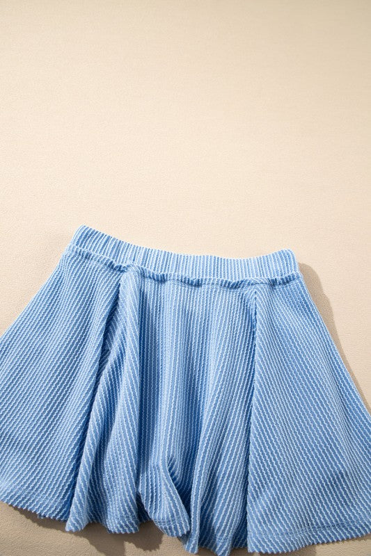 Light blue ruffle mini skirt with elastic waistband, gathered pleats