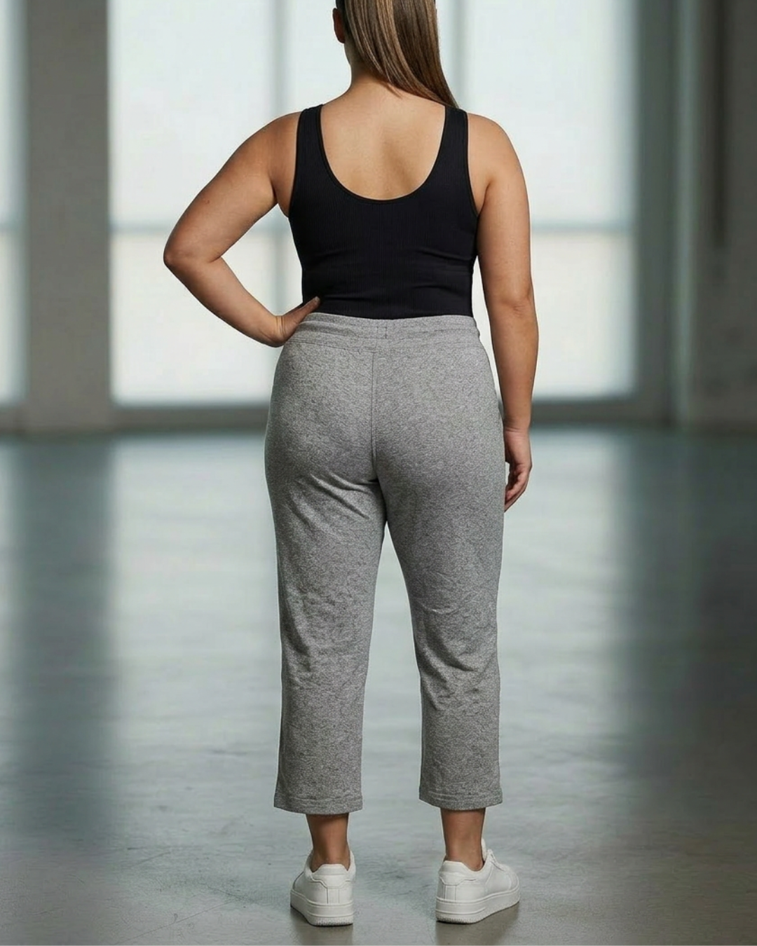 Relaxed capri pants, heather gray with drawstring elastic waist; back view cropped legs.