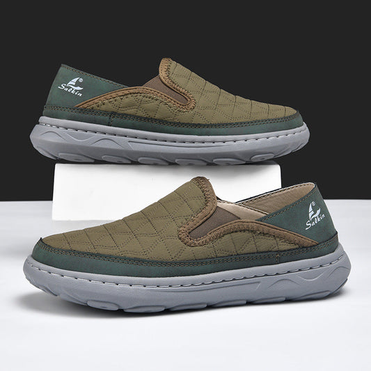 Men's casual travel slip-on shoes in tan with green trim, quilted upper and cushioned sole