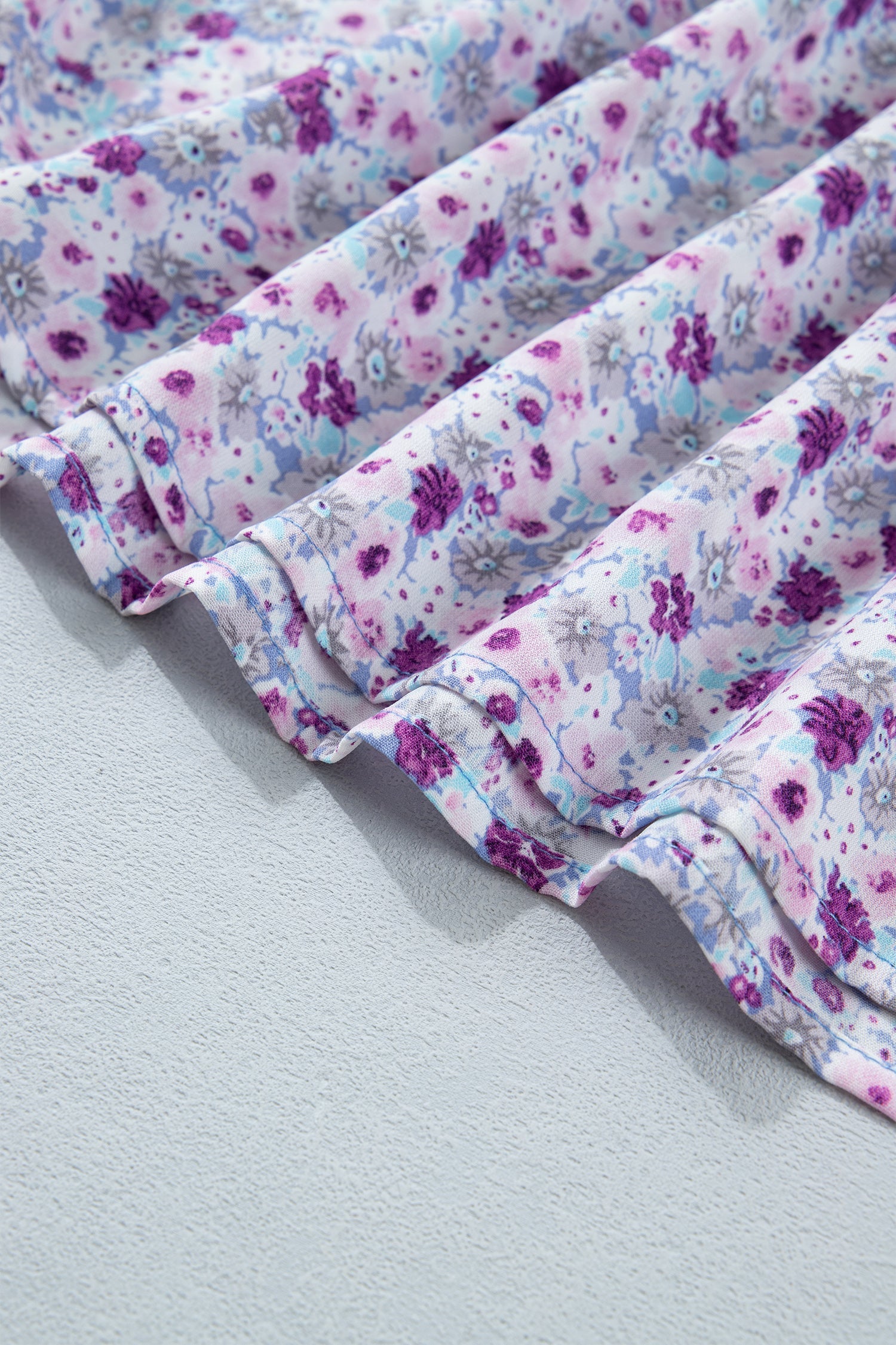 Purple floral smocked maxi dress with square neckline and puff sleeves, tiered skirt
