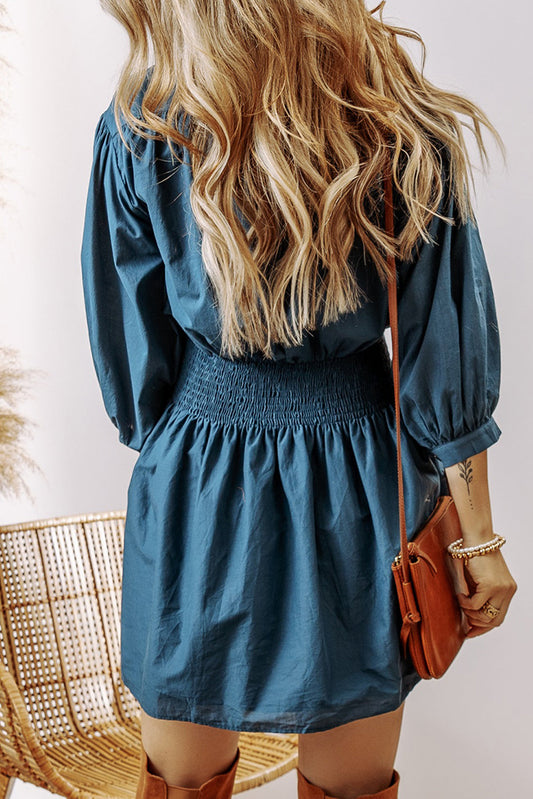 Back view: Prussian blue shirred high-waist button-front dress with puff sleeves