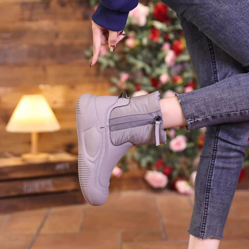 Light grey winter snow boot with side zipper, padded upper, textured sole.