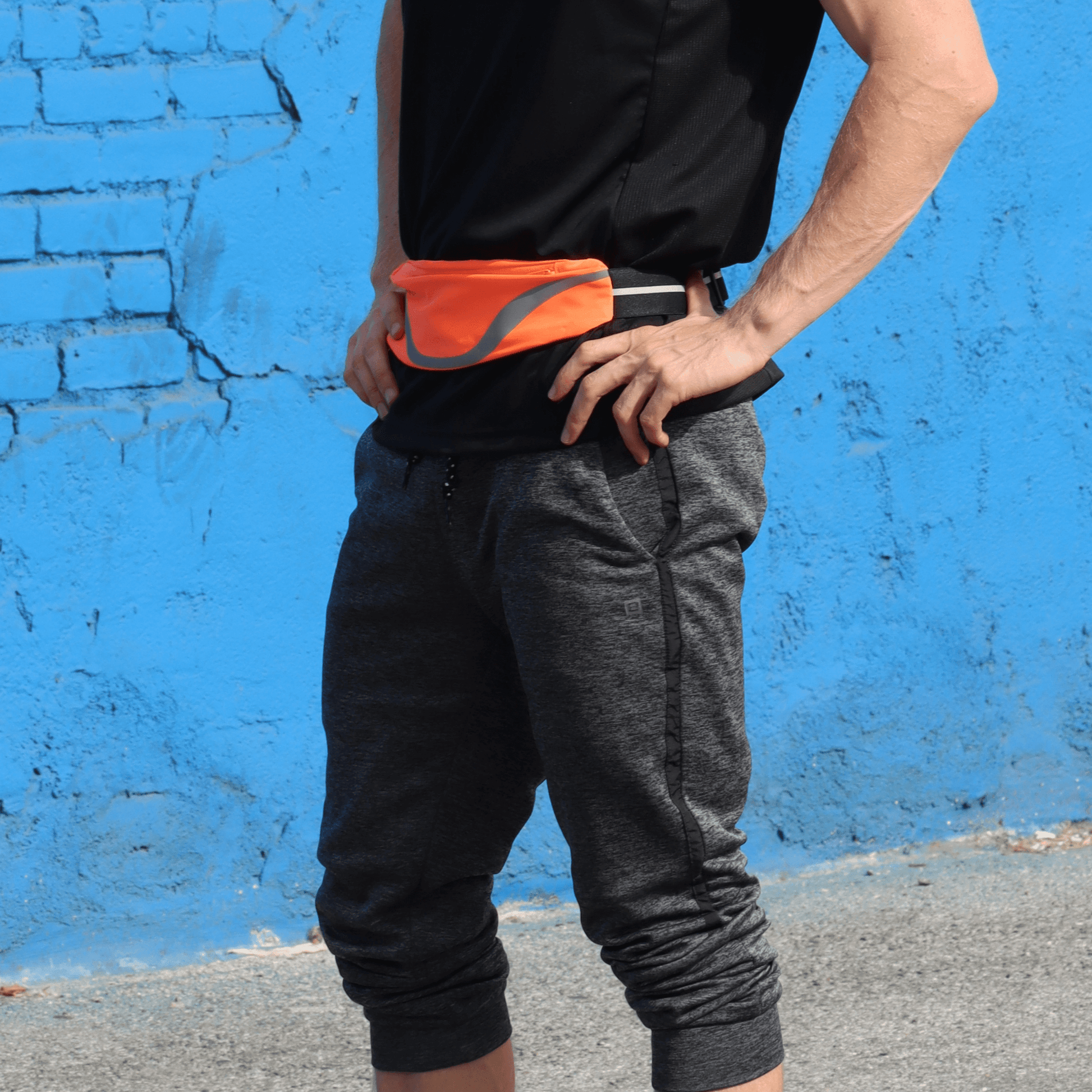 Water-resistant sport waist pack with orange reflective stripe, worn at the waist.