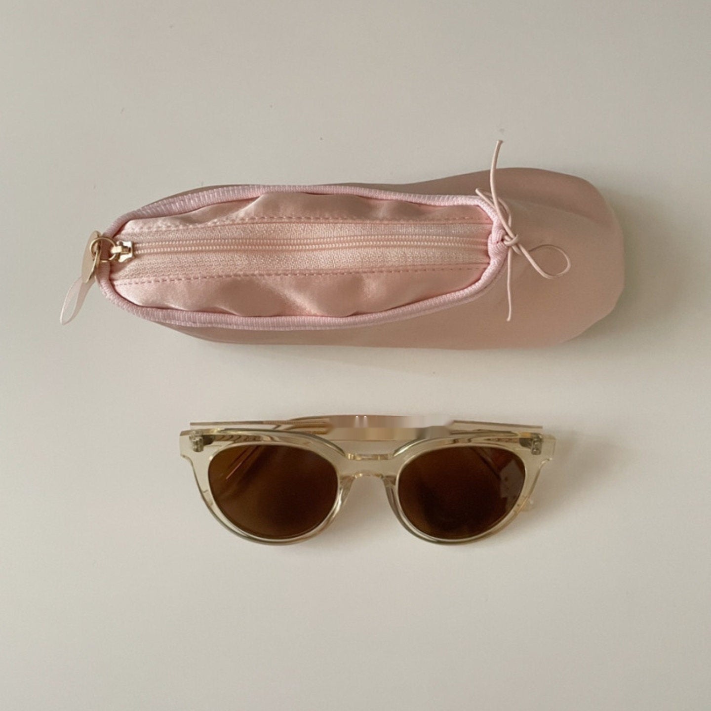Pink ballet shoe makeup pouch with zip closure and bow-tie ribbon