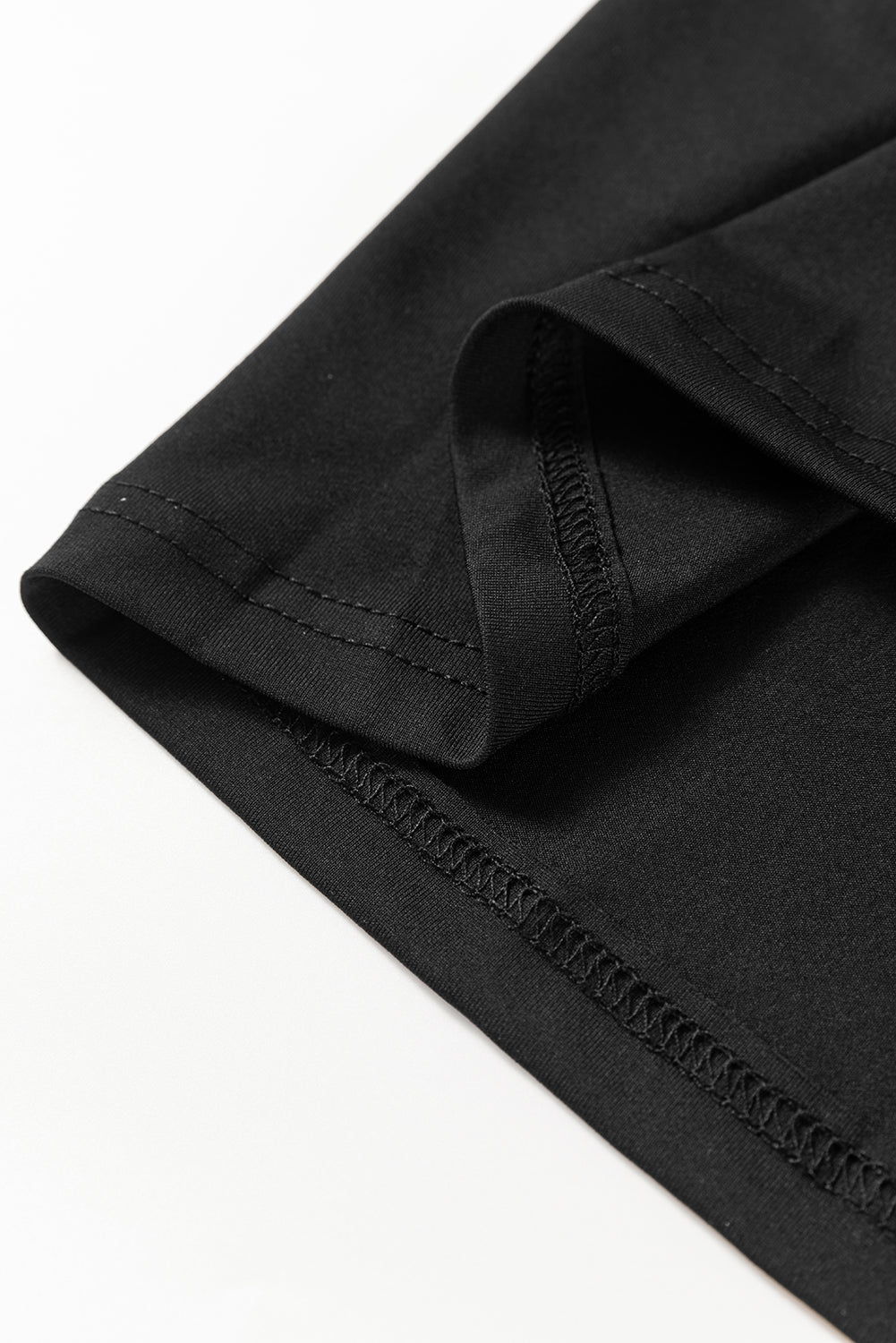 Black dress hem edge with stitching close-up