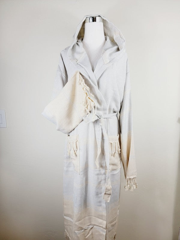 Off-white hooded robe with belt and patch pockets; tasseled sleeve cuffs