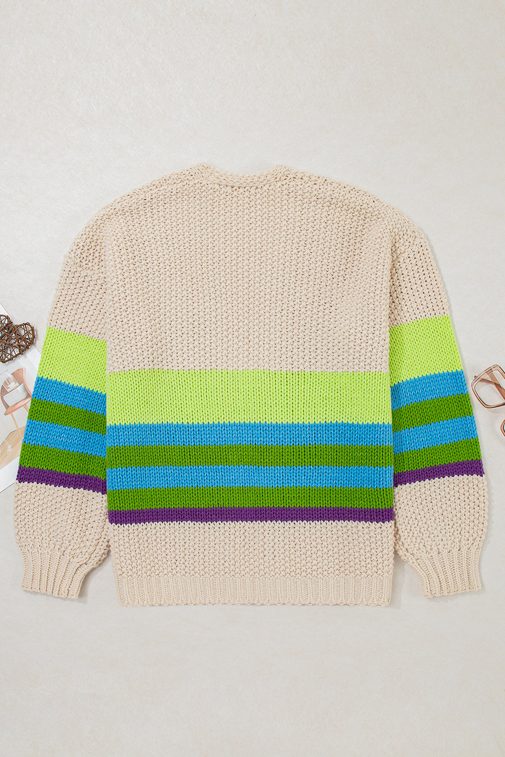 Plus-size crochet cardigan flat lay, back view in parchment with green blue and purple stripe band