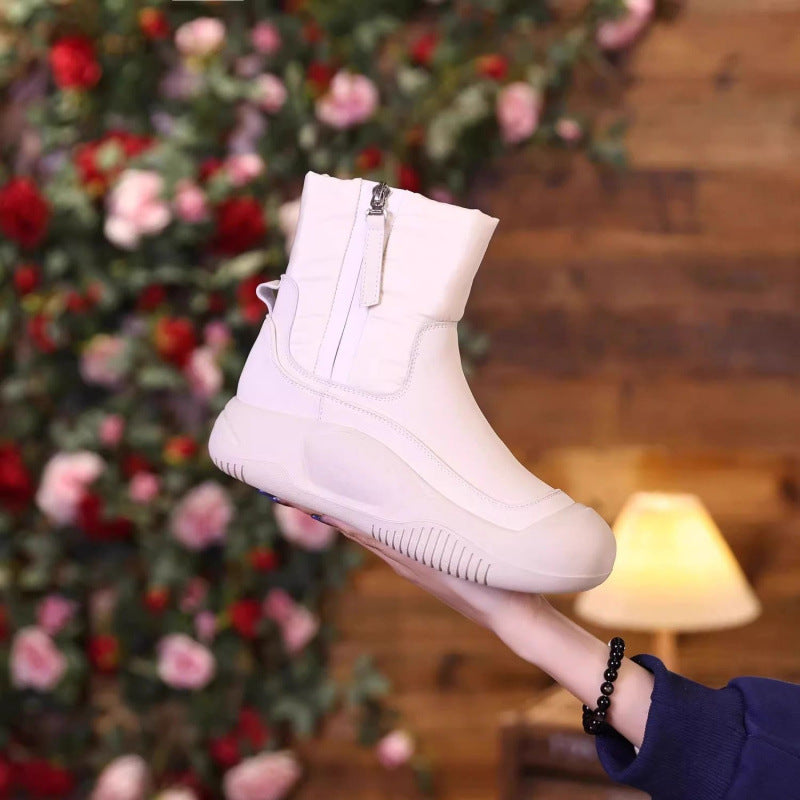 White winter snow boot with side zipper, padded upper, ribbed tread sole.