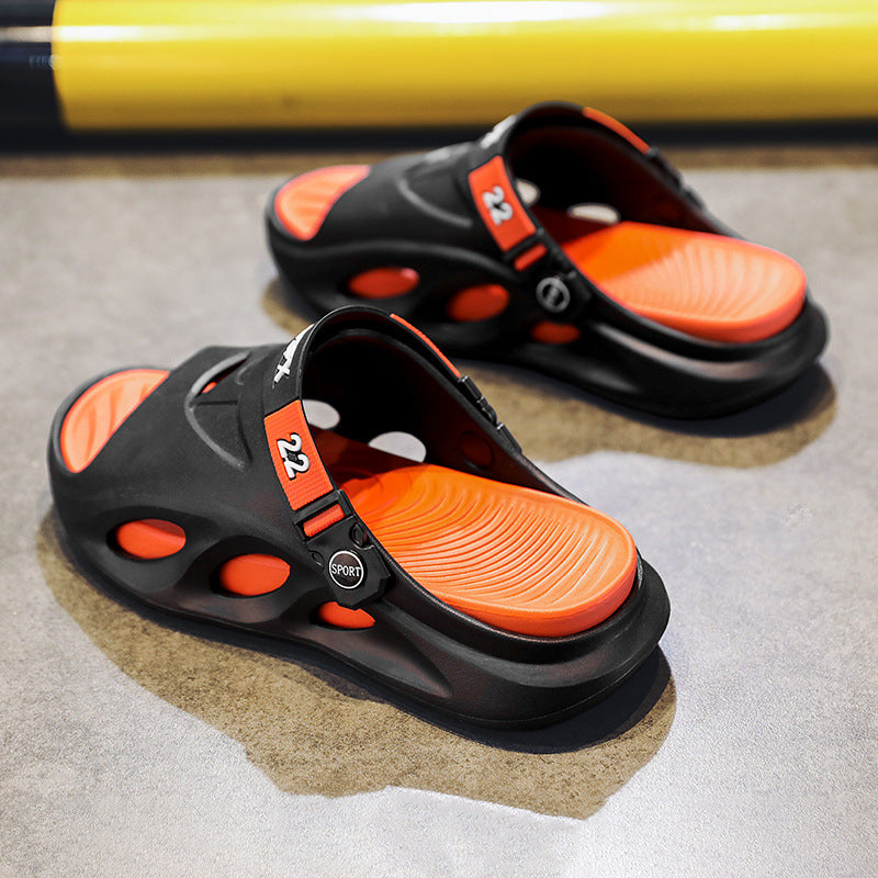 Black slide sandals with orange footbed and orange adjustable strap, openwork upper