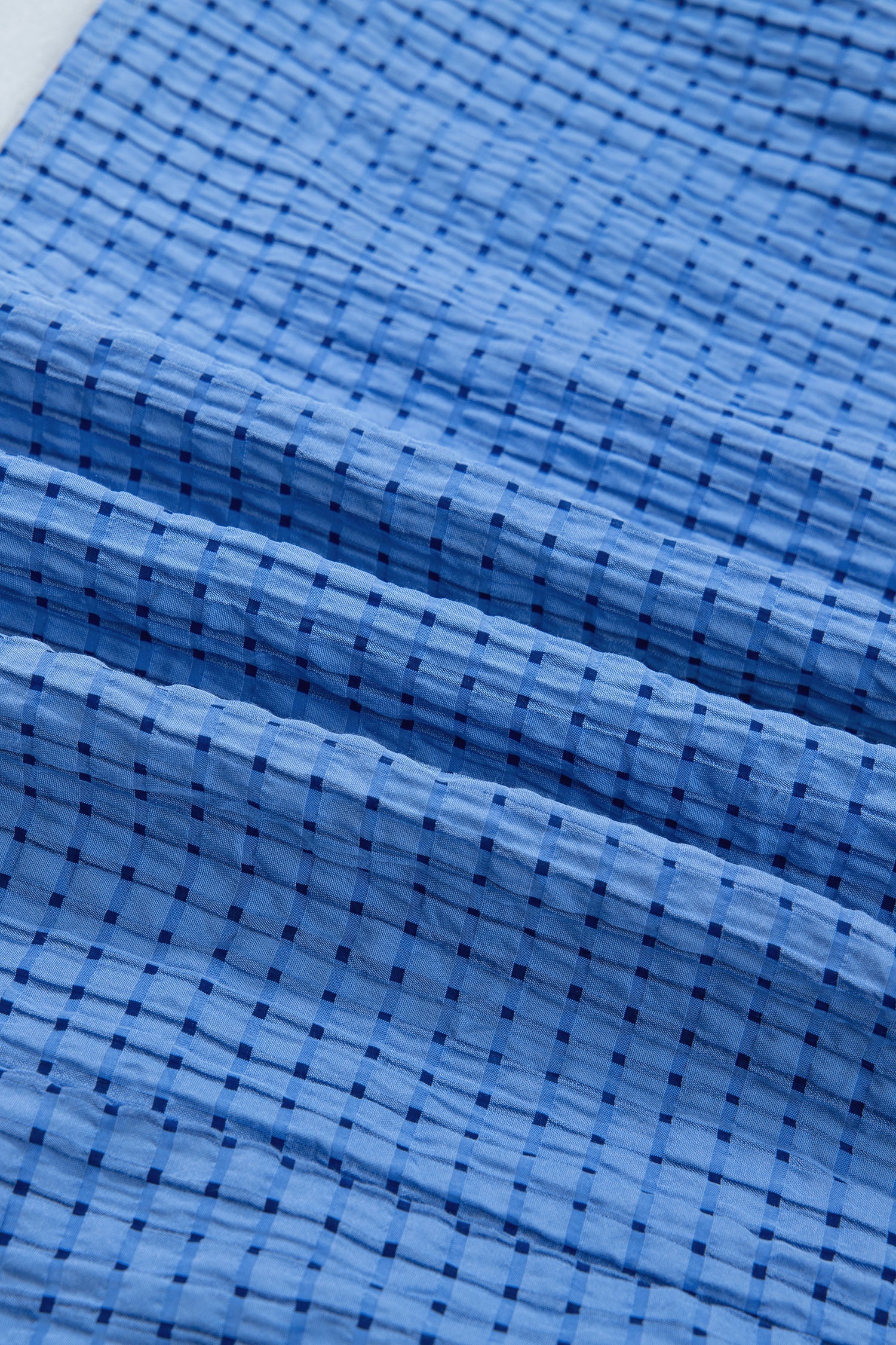 Dusk blue checkered fabric with fine grid texture