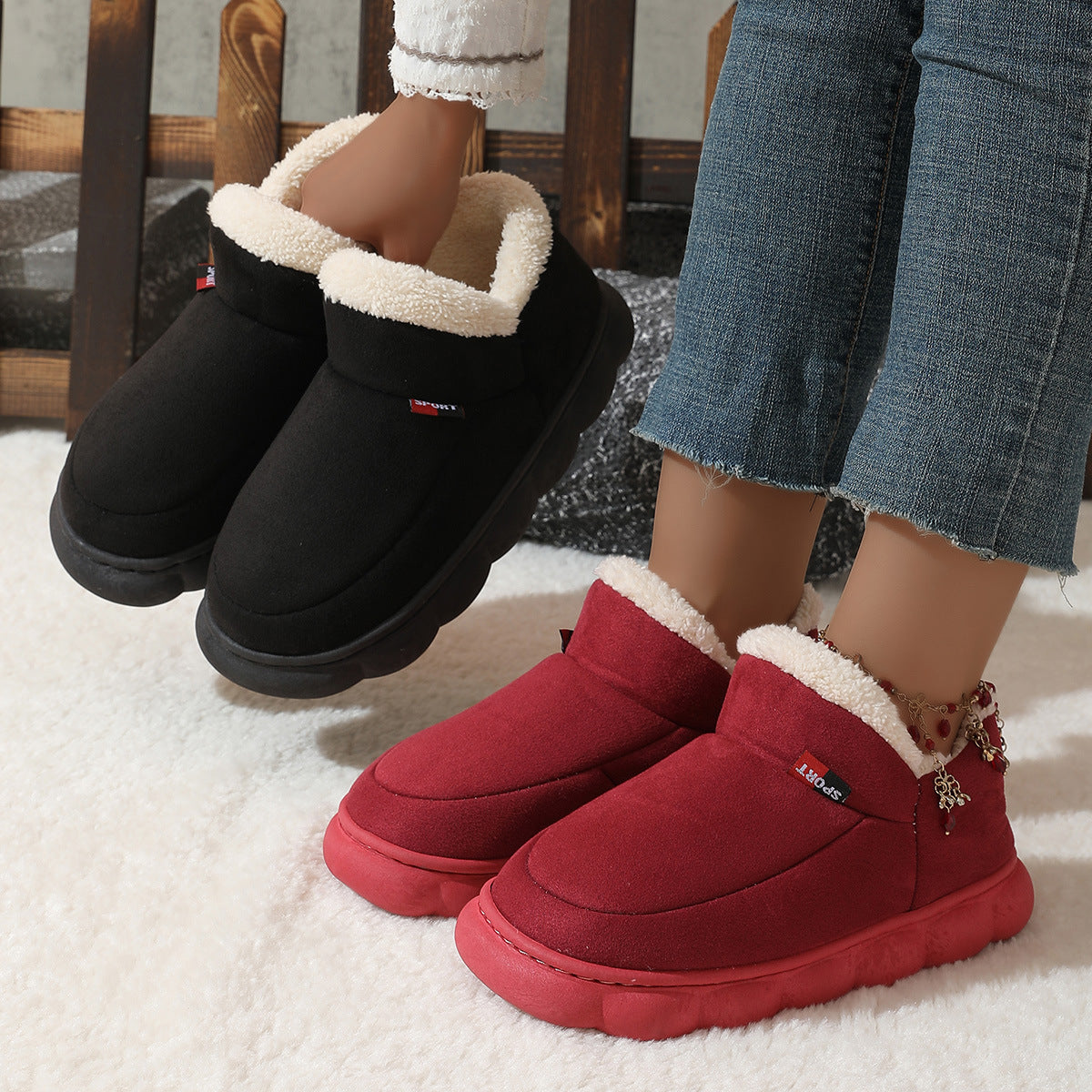 Black and red plush house shoes with fuzzy straps and thick soles