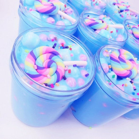 Set of blue slime jars with rainbow lollipop sticks and colorful sprinkles