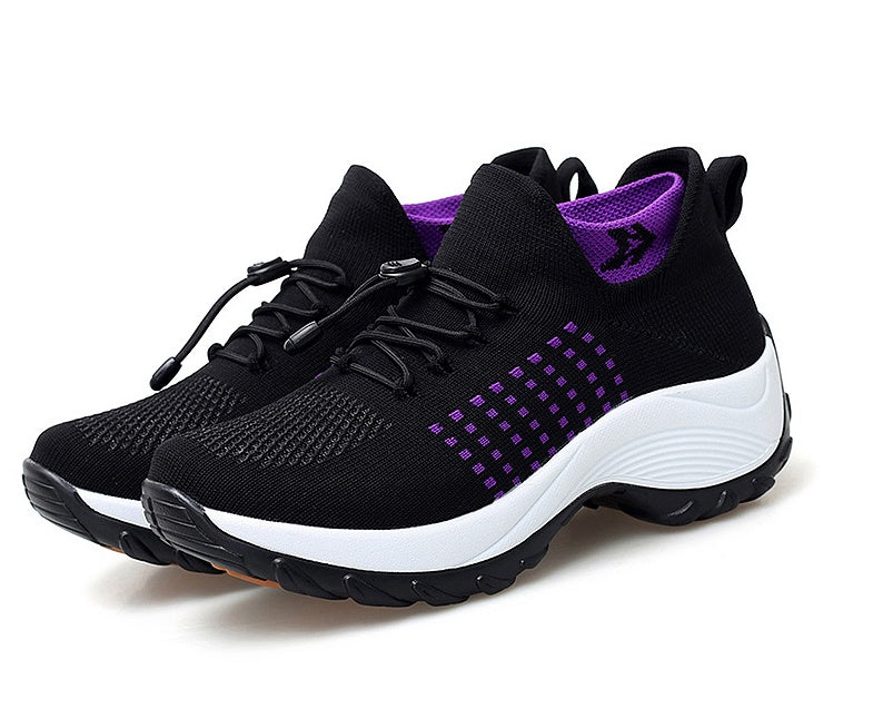 Women’s athletic knit sneaker in black with purple dotted pattern and thick white sole