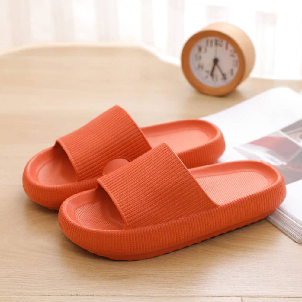 Orange slide sandals with wide strap and cushioned contoured sole for comfort