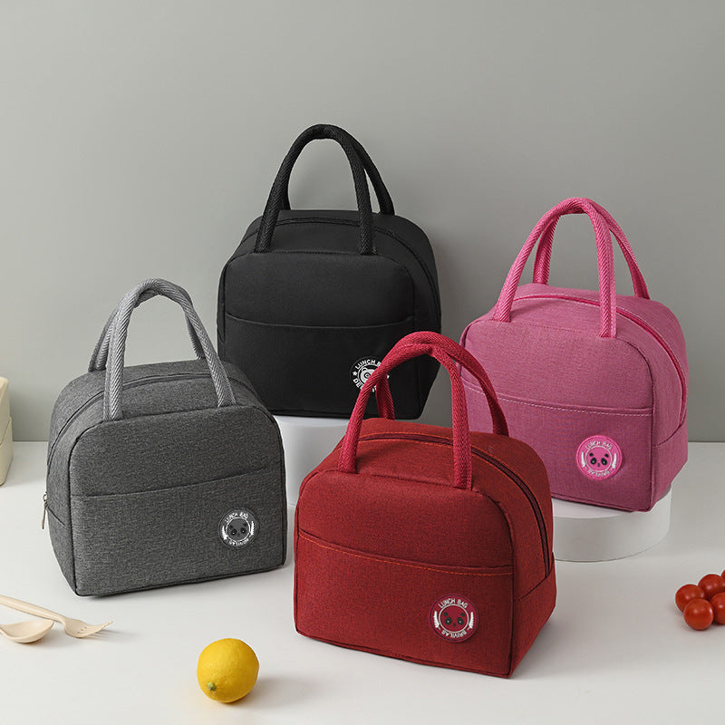 Set of four insulated lunch bags in black, grey, red, and pink with carry handles.