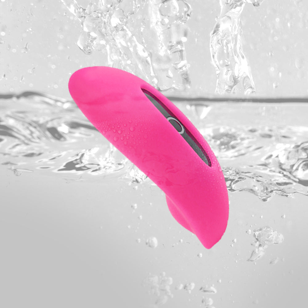 Pink silicone personal massager in water with visible droplets