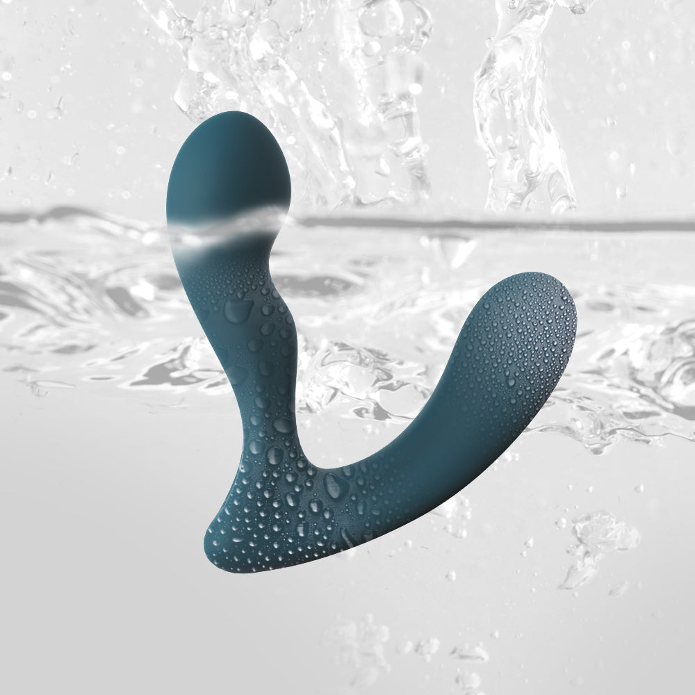 Teal silicone prostate massager with water droplets, curved shape with rounded tip.