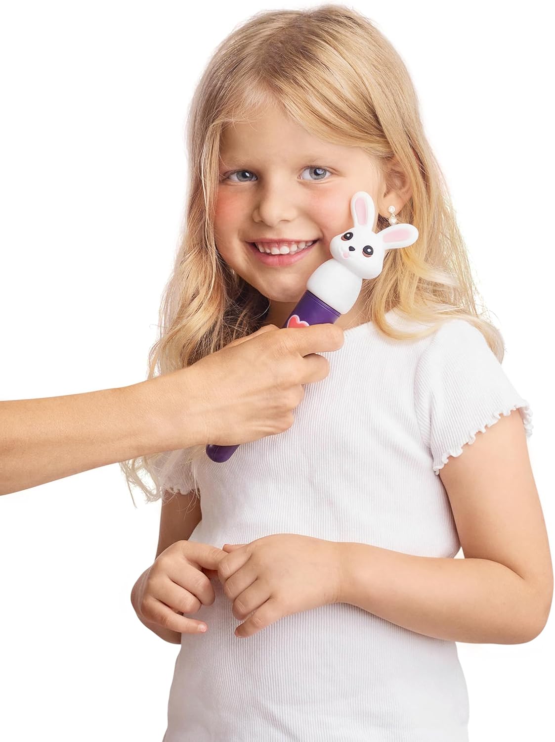 Child holding bunny-headed vibrating oral motor tool next to the face