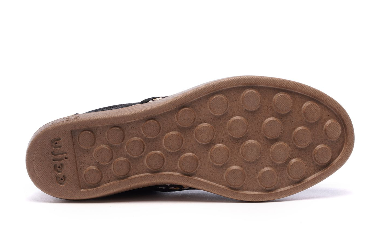 Men's slip-on sneaker outsole with tan tread and circular grip pattern