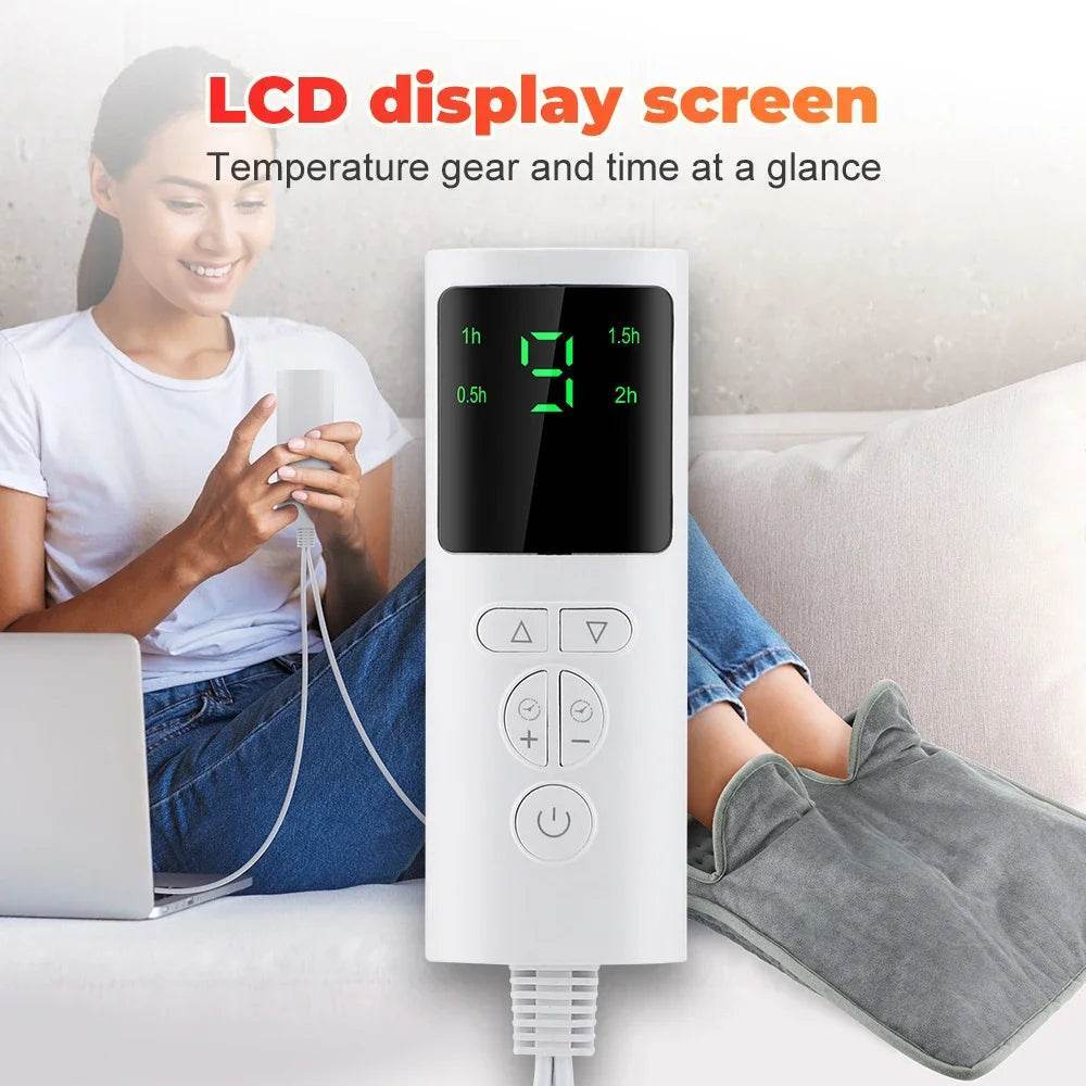 Grey electric foot heating pad connected to LCD controller showing time and temperature